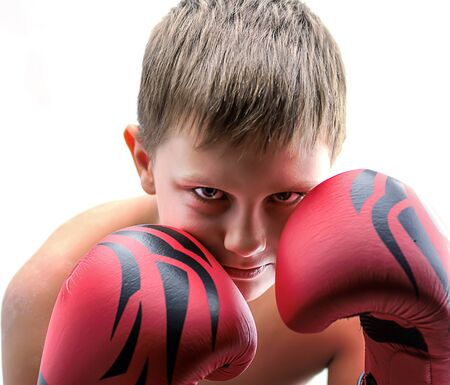 Portrait of a boy in red boxing glovesの写真素材