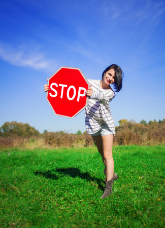 beautiful girl with stop signの写真素材