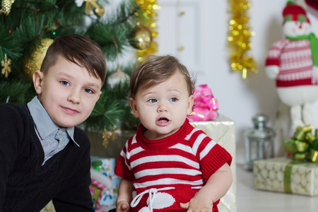 boy and girl near a Christmas treeの写真素材