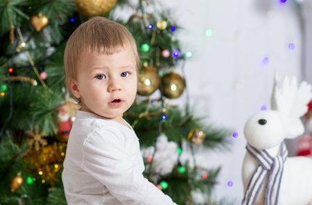 Portrait of a cute boy near Christmas treeの写真素材