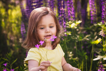 Little girl among the flowersの写真素材