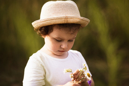 little girl is playing on nature in summerの写真素材