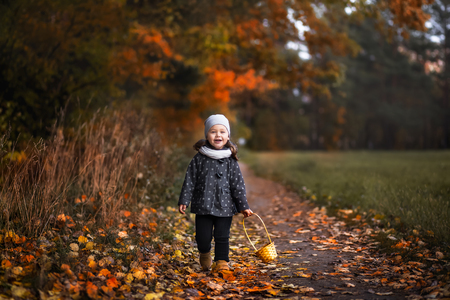 girl walking in the forest in autumnの写真素材