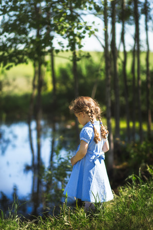 portrait of a girl with pigtails on nature, emotionsの写真素材