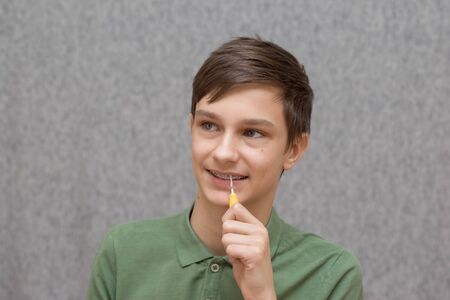 teenager with braces and toothbrush