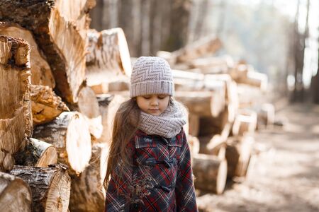 little cute girl on a forest path in springの写真素材