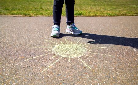 sun is drawn in chalk on the pavementの写真素材