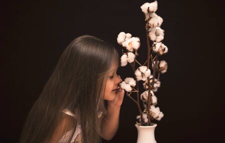 little cute girl with a bouquet of cottonの写真素材