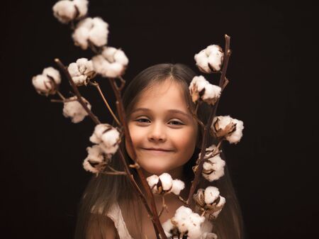 little cute girl with a bouquet of cottonの写真素材