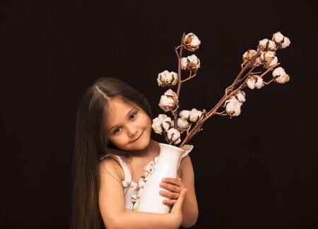 little cute girl with a bouquet of cottonの写真素材