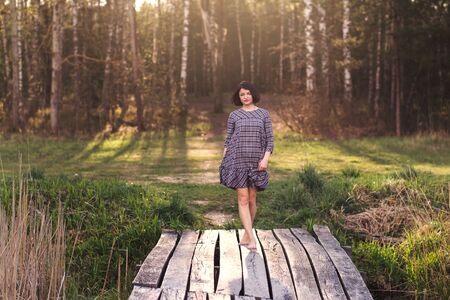 young cute girl dancing in natureの写真素材