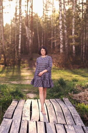 young cute girl dancing in natureの写真素材