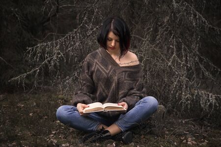young woman reading a bookの写真素材