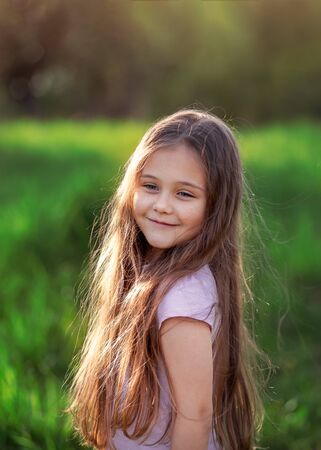 portrait of a little girl with long hair on summerの写真素材