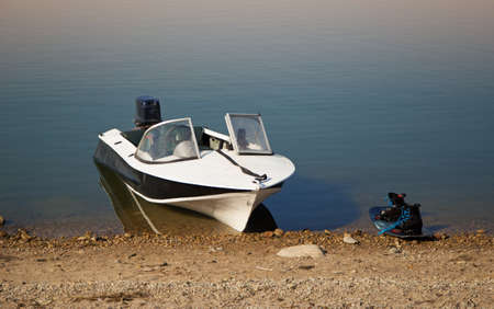 motor boat and wakeboard on the shore