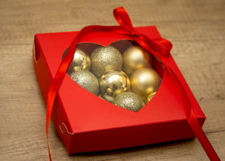 New Year and Christmas balls in a red gift box