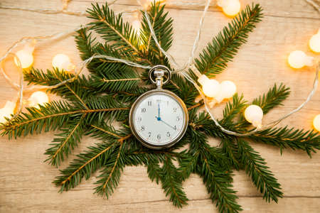 clock with arrows at midnight with fir branches. New yearの写真素材