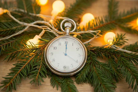 clock with arrows at midnight with fir branches. New yearの写真素材