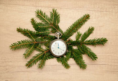 clock with arrows at midnight with fir branches. New yearの写真素材