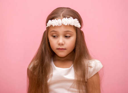 little pink gift box in the hands of a girl.