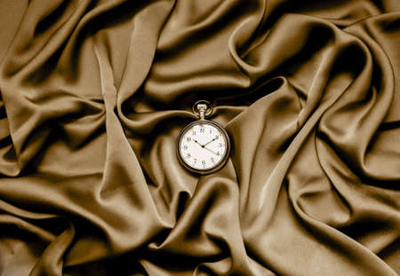 round clock on a fabric background. set sail champagne