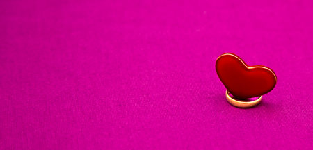 Wedding ring and heart on a pink background. Banner