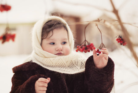 Little girl walks in nature in winter. Winter clothingの写真素材