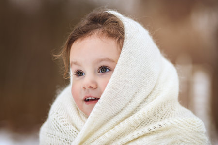 Little girl walks in nature in winter. Winter clothingの写真素材