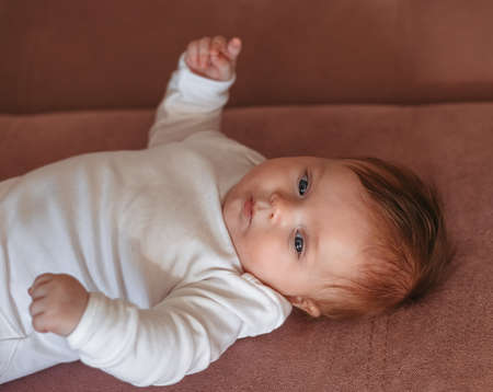 A close-up portrait of a newborn baby. Look into the cameraの写真素材