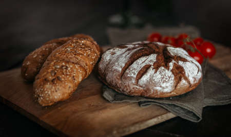 Fresh baked bread on wooden background.の写真素材