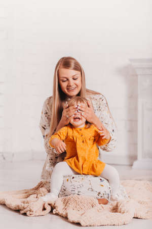 Young mom and her little daughter have fun together. Verticalの写真素材