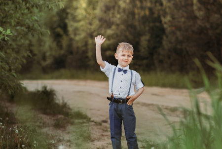little cute boy in an oilseed rape field. Rural landscape. Verticalの写真素材