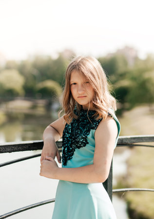 Beautiful teenage girl walking in the park in the summerの写真素材