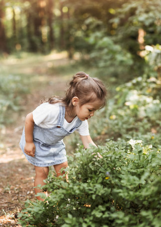 Positive charming little girl enjoying summer sunny day, expression emotions, having fun, happy...