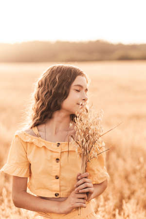 Beautiful girl in nature in the summer with a colorful umbrellaの写真素材