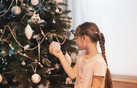 Beautiful child girl near a Christmas tree. Christmas concept.の写真素材