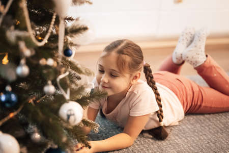 Beautiful child girl near a Christmas tree. Christmas concept.の写真素材