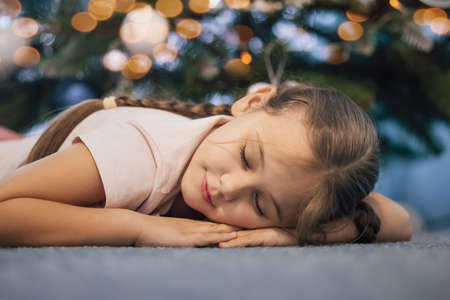 Beautiful child girl near a Christmas tree. Christmas concept.の写真素材