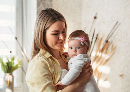 happy family mother playing with newborn baby