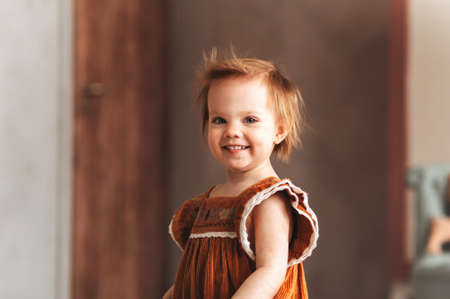 happy teenage boy sitting home on bed, little girl, brother and sister hugging. concept happy family, childhoodの写真素材