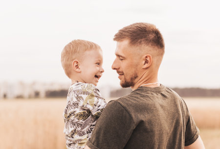 Father's day. Happy family father and toddler son playing and laughing on nature at sunset