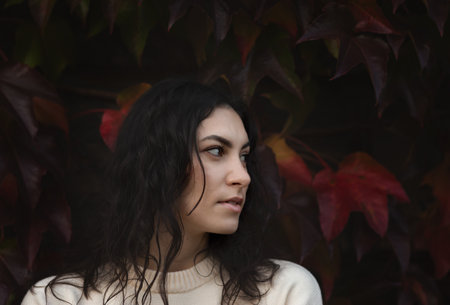 Fashion woman on a background of red and yellow autumn leaves