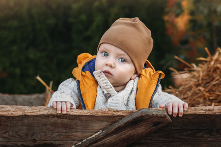 A toddler on a pumpkin farm with a large orange pumpkin, nice sunny family day at a pumpkin patch...