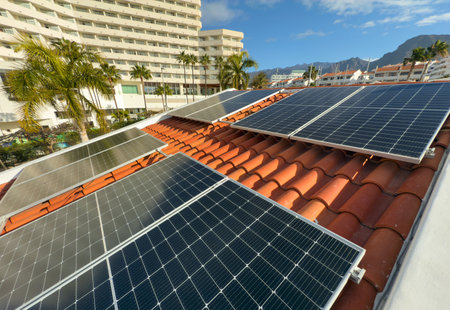 Solar panels installed on the roof of a house in a sunny coastal resort town. Alternative energy