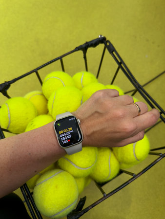 Hand with watch for sports and tennis balls. Tracking for tennis. Health and sportsの写真素材