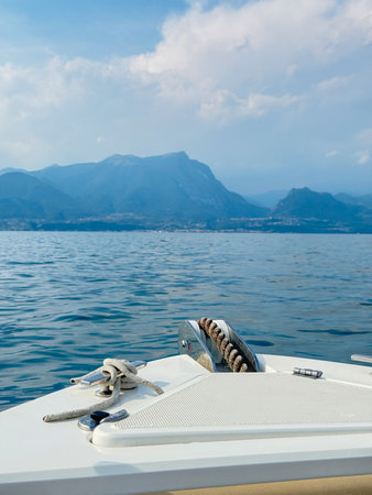 view of the lake and mountains from the deck of a water motor boat. Sea trip