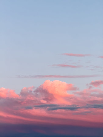 The sky at sunset is painted in pink and blue tones with beautiful cloudsの写真素材