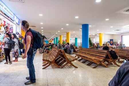 Belize City, Belize - November, 18, 2019. Passengers waiting for their flights inside international Philip S W Goldson Airport.のeditorial素材