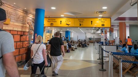 Belize City, Belize - November, 18, 2019. Passengers waiting for their flights inside international Philip S W Goldson Airport.のeditorial素材