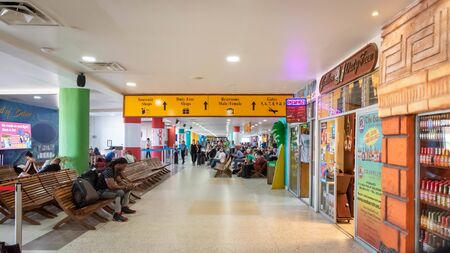 Belize City, Belize - November, 18, 2019. Passengers waiting for their flights inside international Philip S W Goldson Airport.のeditorial素材